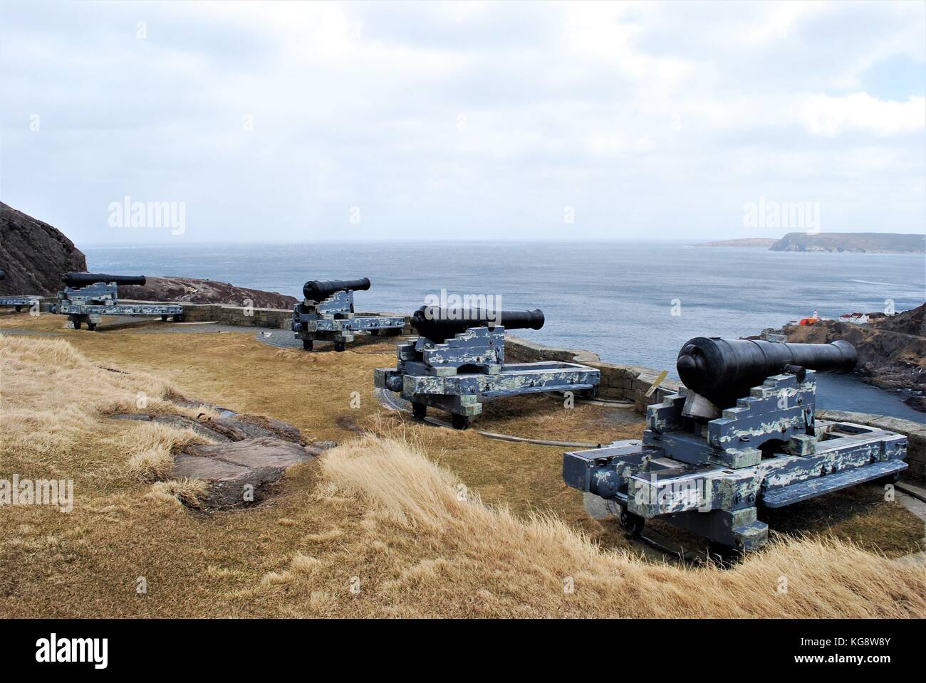 Old cannons line the hillside, overlooking St. John's Harbour, at the Queen's Battery, Signal Hill, St. John's, Newfoundland Stock Photo