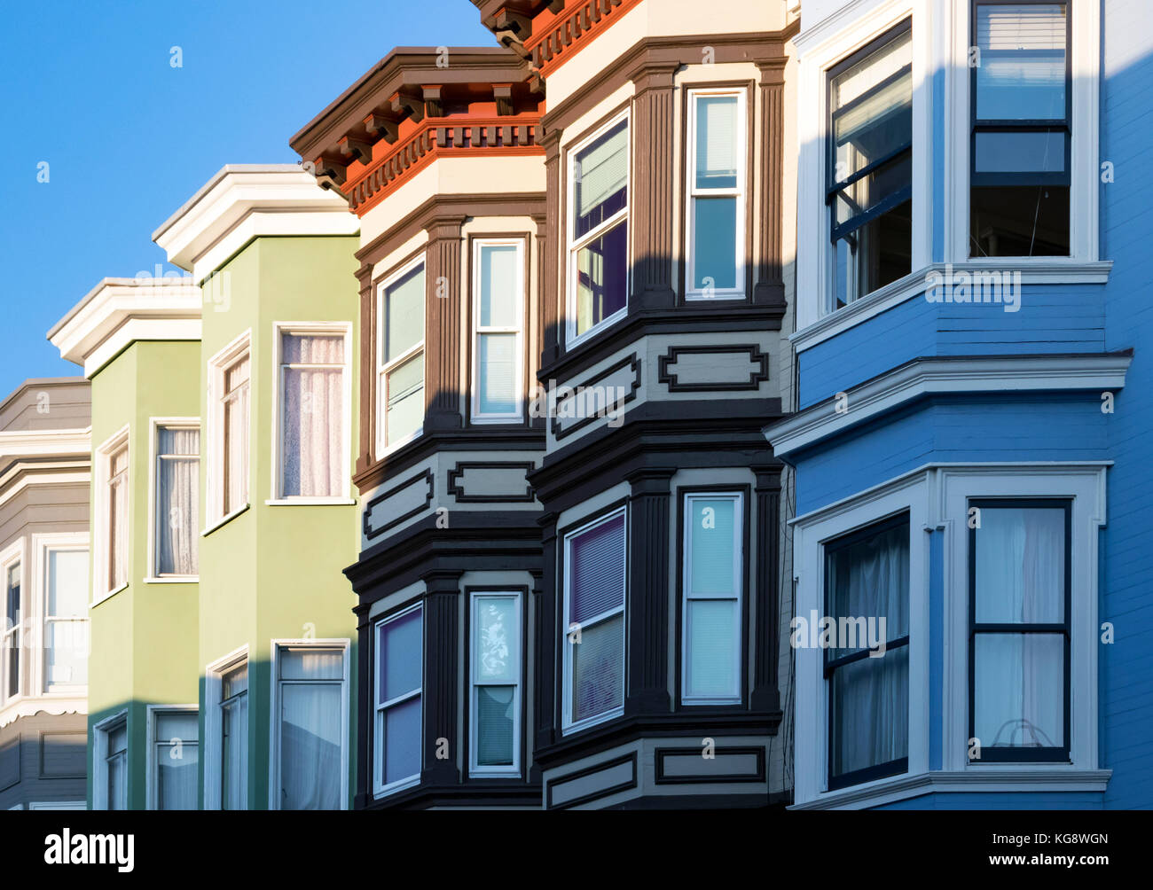 Row of colorful buildings with classic bay windows architecture in San ...