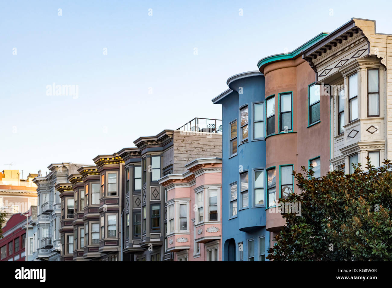 Sunset light shines on a row of colorful buildings on Filbert Street in