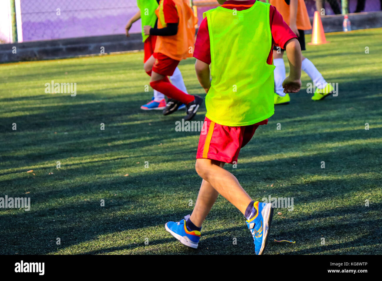 Kids on the green field play soccer Stock Photo - Alamy