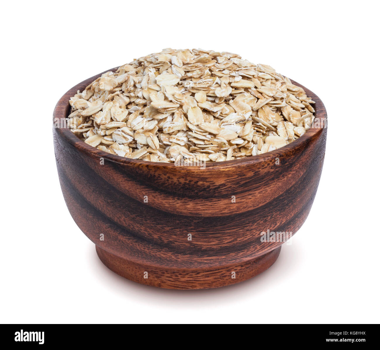 Isolated oatmeal. Oat flakes in wooden bowl on white background Stock Photo