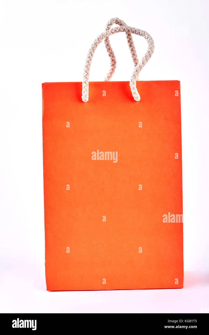 Orange shopping bag on white background Stock Photo - Alamy