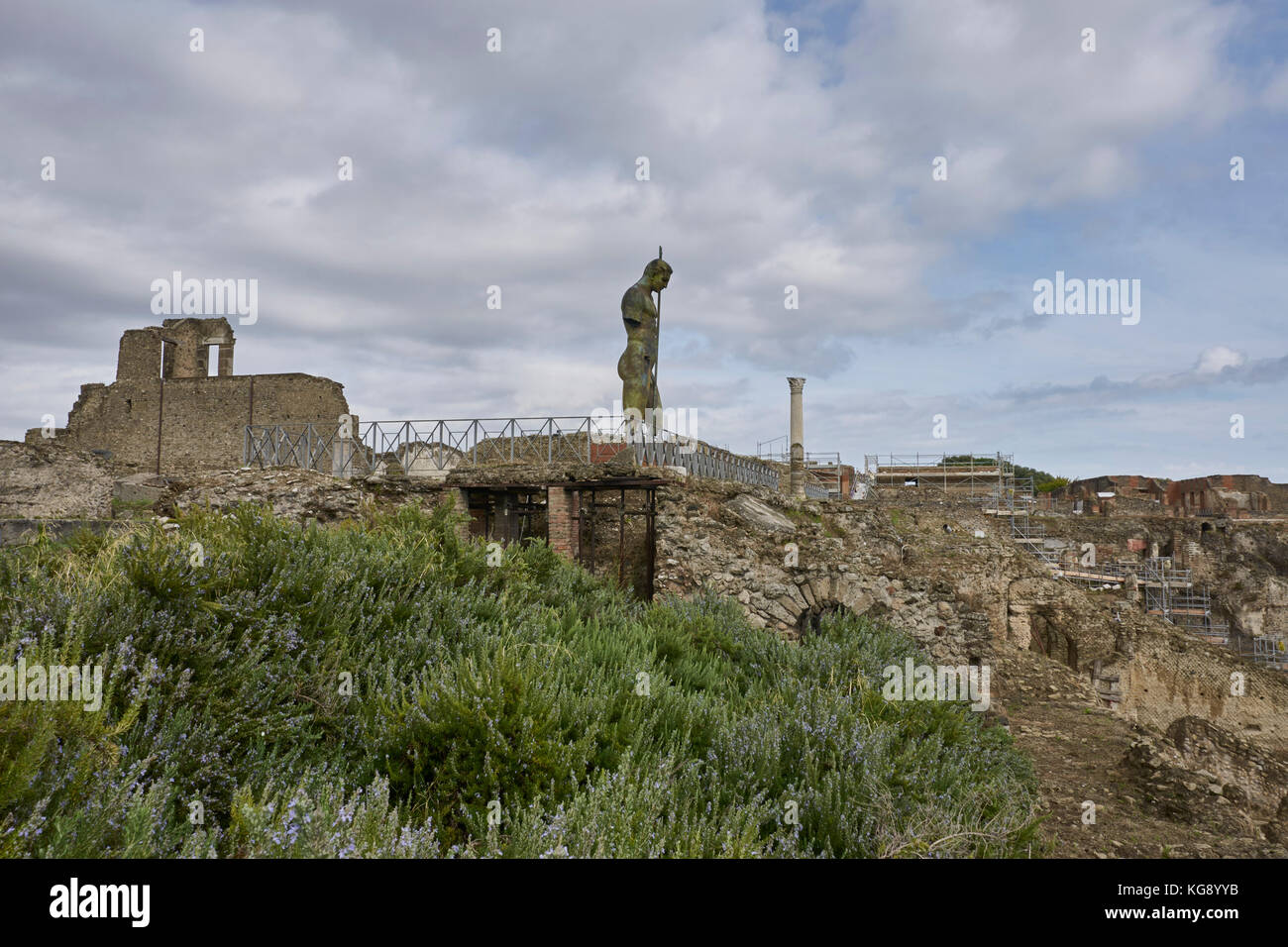 Pompeii ruins exhibited after archaeological excavations. Modern sculpture by the sculptor Igor Mitoraj adjacent to temple ruins. Stock Photo