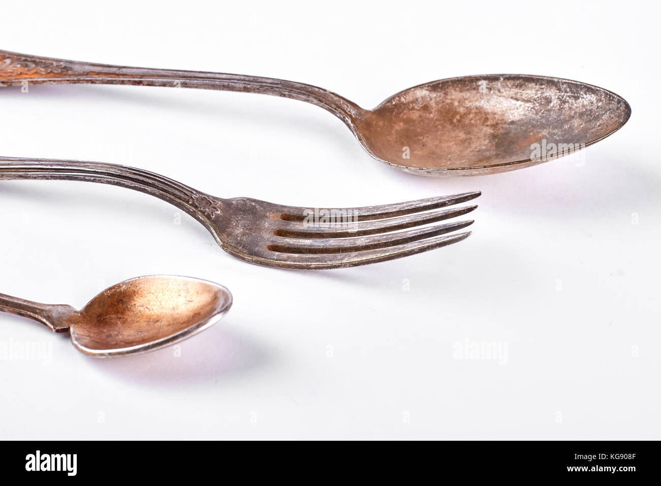 Antique spoons and fork, white background Stock Photo - Alamy