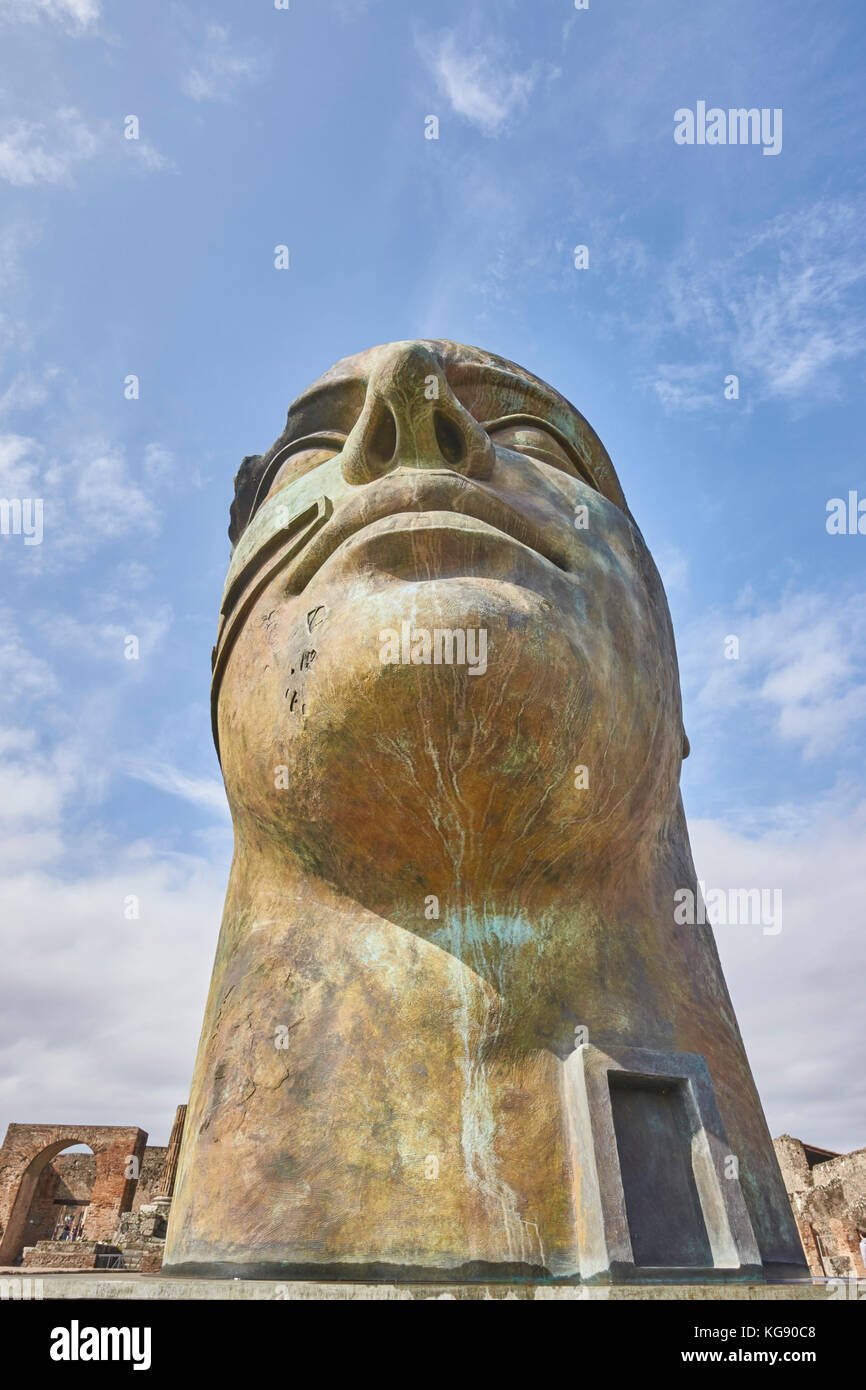 Pompeii ruins exhibited after archaeological excavations. Modern sculptures placed around the site by the sculptor Igor Mitoraj. Bronze head 'Tindaro' Stock Photo