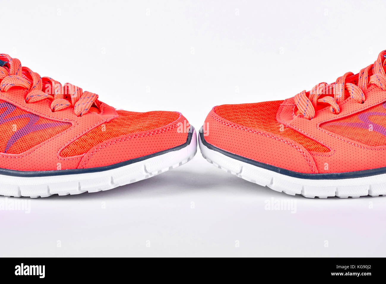 Orange sport shoes, white background Stock Photo - Alamy