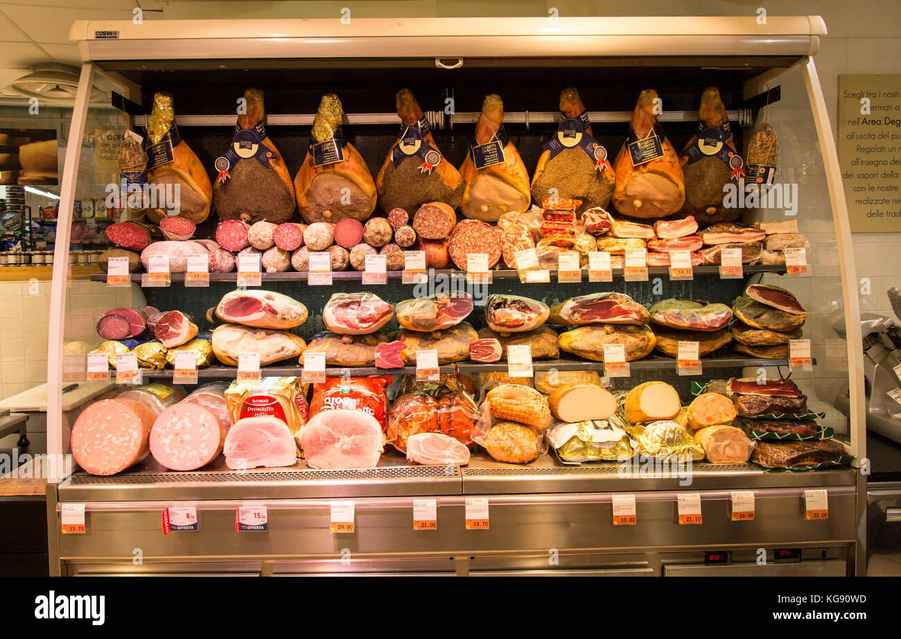 Selection of cured meats and hams on display in a local deli grocer in Florence Stock Photo