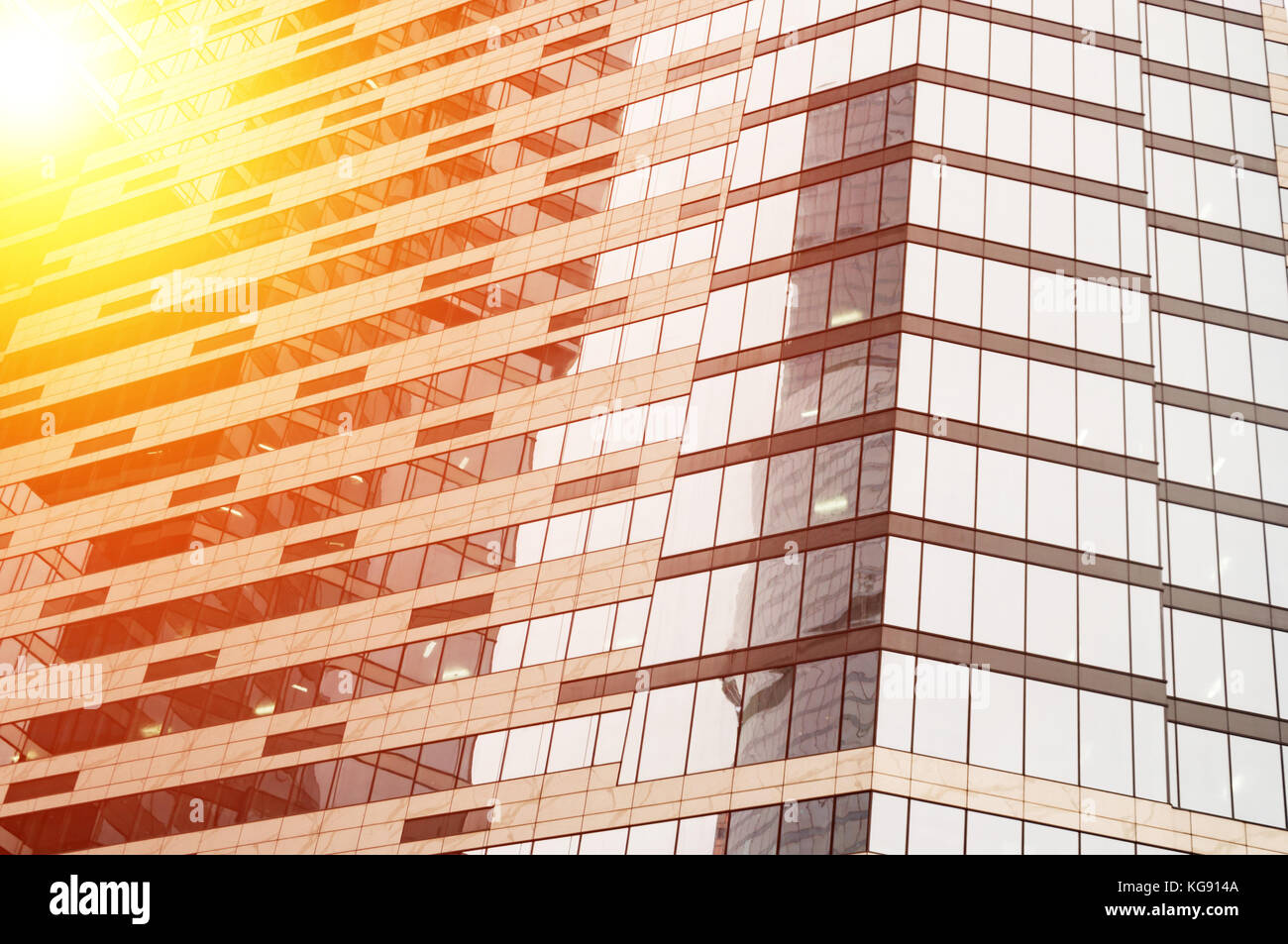 Modern glass building business center. Skyscraper in the city. The sun's rays are reflected in the glass surface of the building. Bottom view Stock Photo