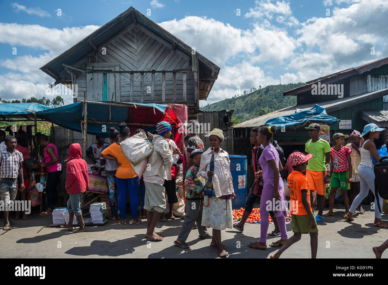 Malagasy people walk and shop at a street market. Madagascar, Africa. Stock Photo