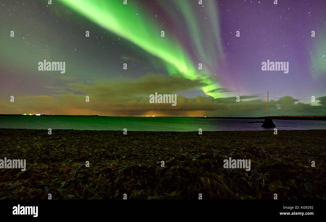 Northern lights Aurora Borealis above landscape in Iceland Stock Photo ...