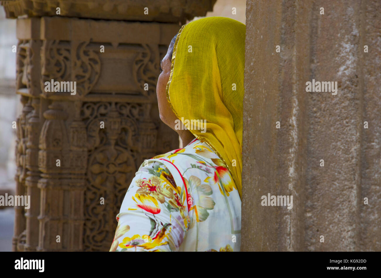 Woman watching sculptures in Adalaj Ni Vav (Stepwell) or Rudabai Stepwell. Built in 1498 by Rana Veer Singh is intricately carved and is five stories  Stock Photo