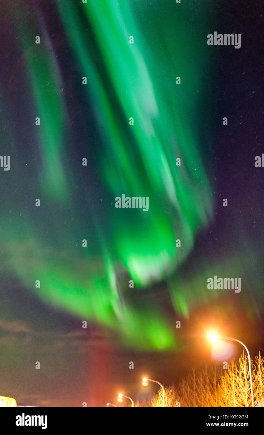 Northern lights Aurora Borealis above street in Iceland Stock Photo - Alamy