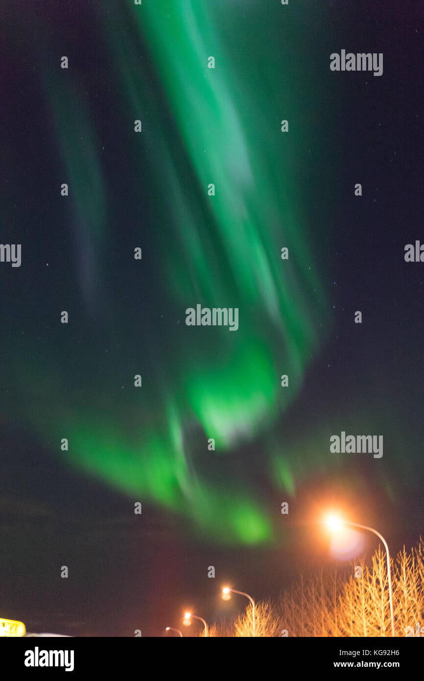 Northern lights Aurora Borealis above street in Iceland Stock Photo - Alamy