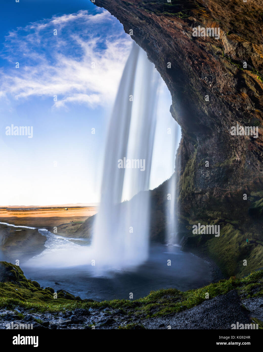 Cave behind Seljalandsfoss Waterfall in Iceland with long Exposu Stock Photo