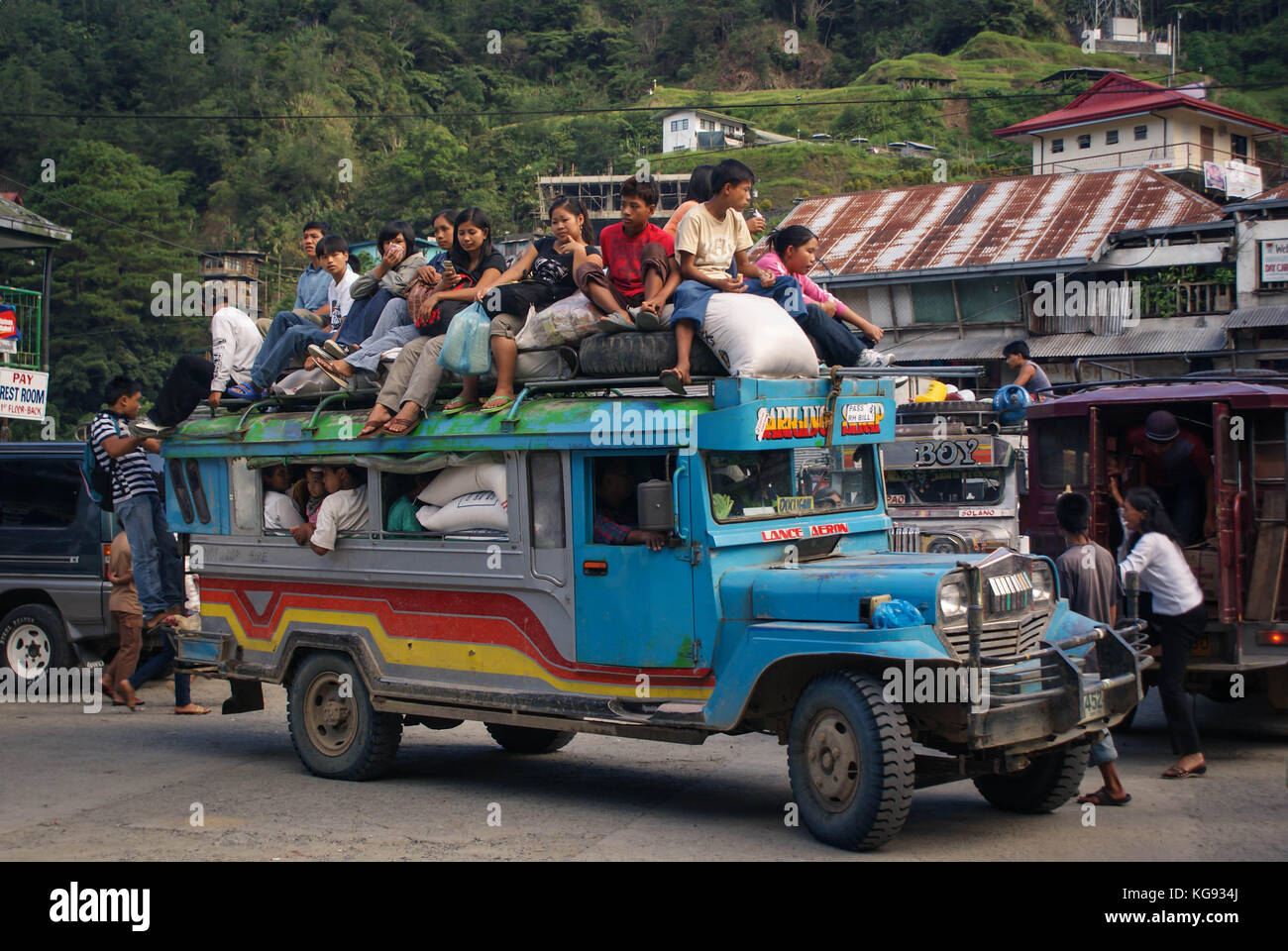 Banaue, Philippines - June 17, 2009: Typical Jeepney overloaded with passengers near Banaue, North Luzon, Philippines. Jeepneys are both cheap public  Stock Photo