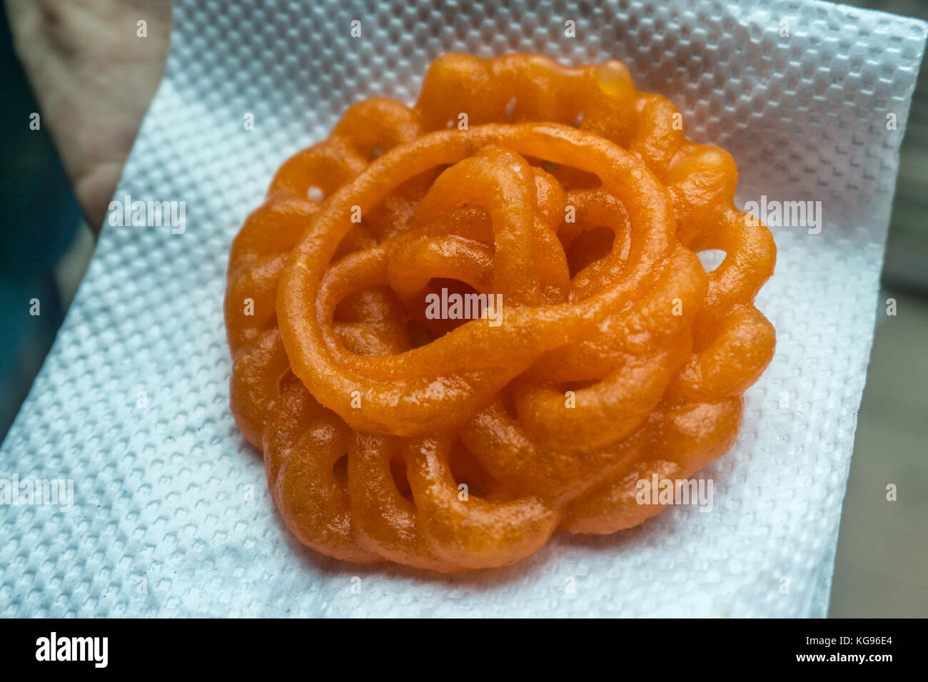 Jalebi deepfrying wheat flour that is then soaked in sugary syrum