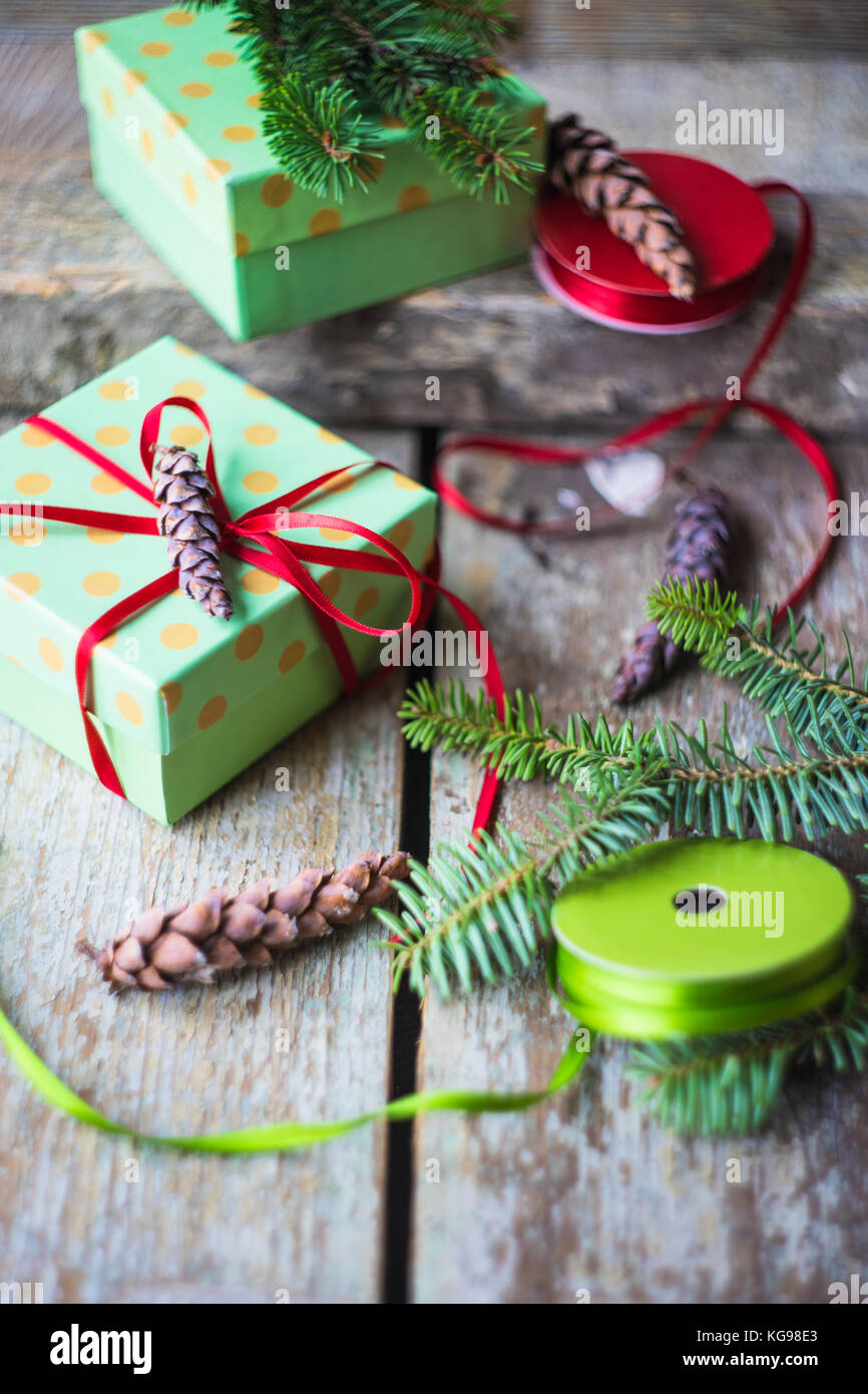 Christmas concept with gift boxes, ribbon and cones on rustic vintage