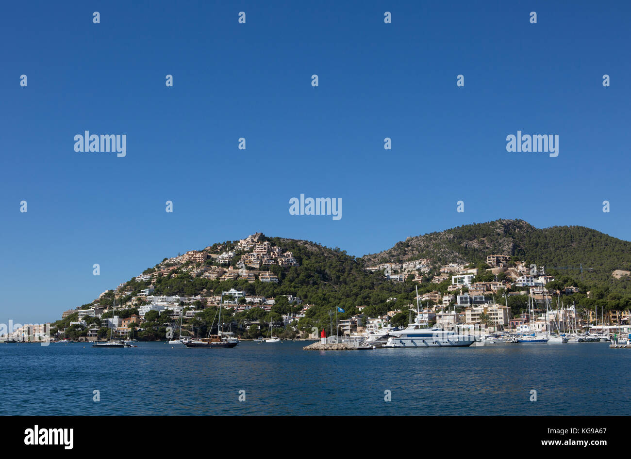 Boats moored at harbour, mountains and town in background, Port d' Andratx, Majorca, Balearic Islands, Spain. Stock Photo