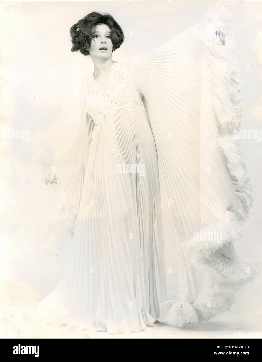 Model wearing a long wide white dress, 1960s Stock Photo