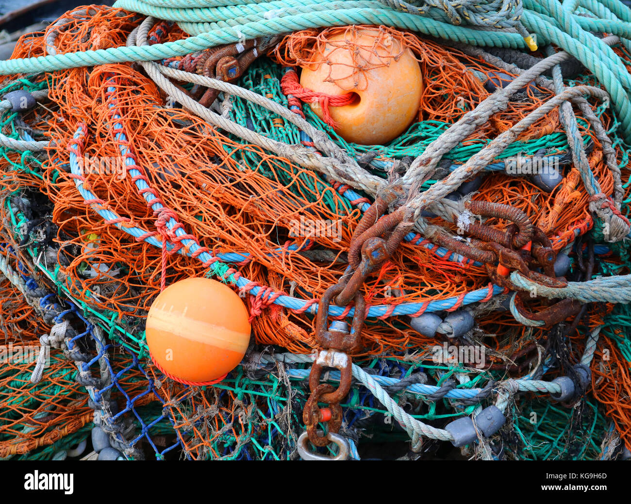 Pile of Fish Nets Buoys and Chains Close Up Stock Photo