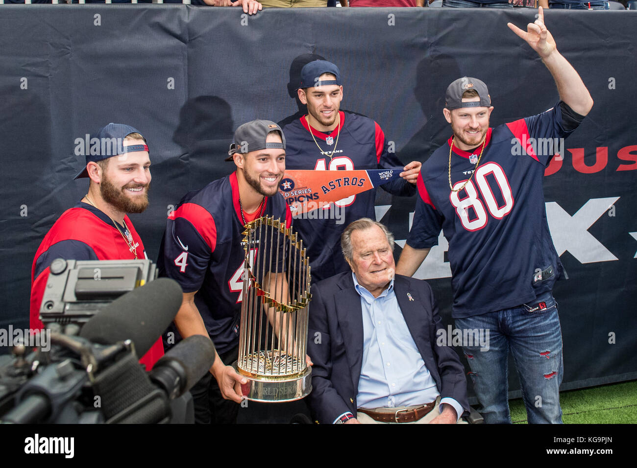 Houston, TX, USA. 5th Nov, 2017. Houston Astros players, Tyler White,  George Springer, Joe Musgrove, and Chris Devenski show off the World Series  trophy while posing with former U.S. President George H.W.