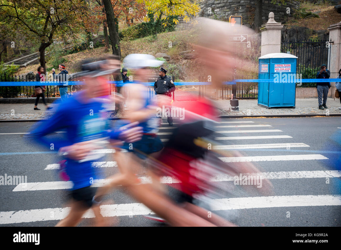 New York, USA. 05th Nov, 2017. An NYPD officer on duty as runners pass ...