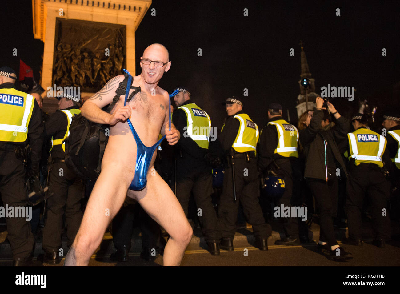 London, United Kingdom. 05th Nov, 2017. Million Mask March 2017 takes place in central London. A protester in a 'mankini' gyrate behind a line of police. Credit: Peter Manning/Alamy Live News Stock Photo