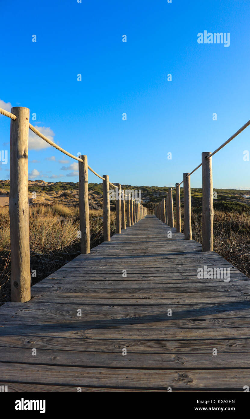 Wooden path to the beach on the dunes. Guincho beach in Cascais, Portugal Stock Photo