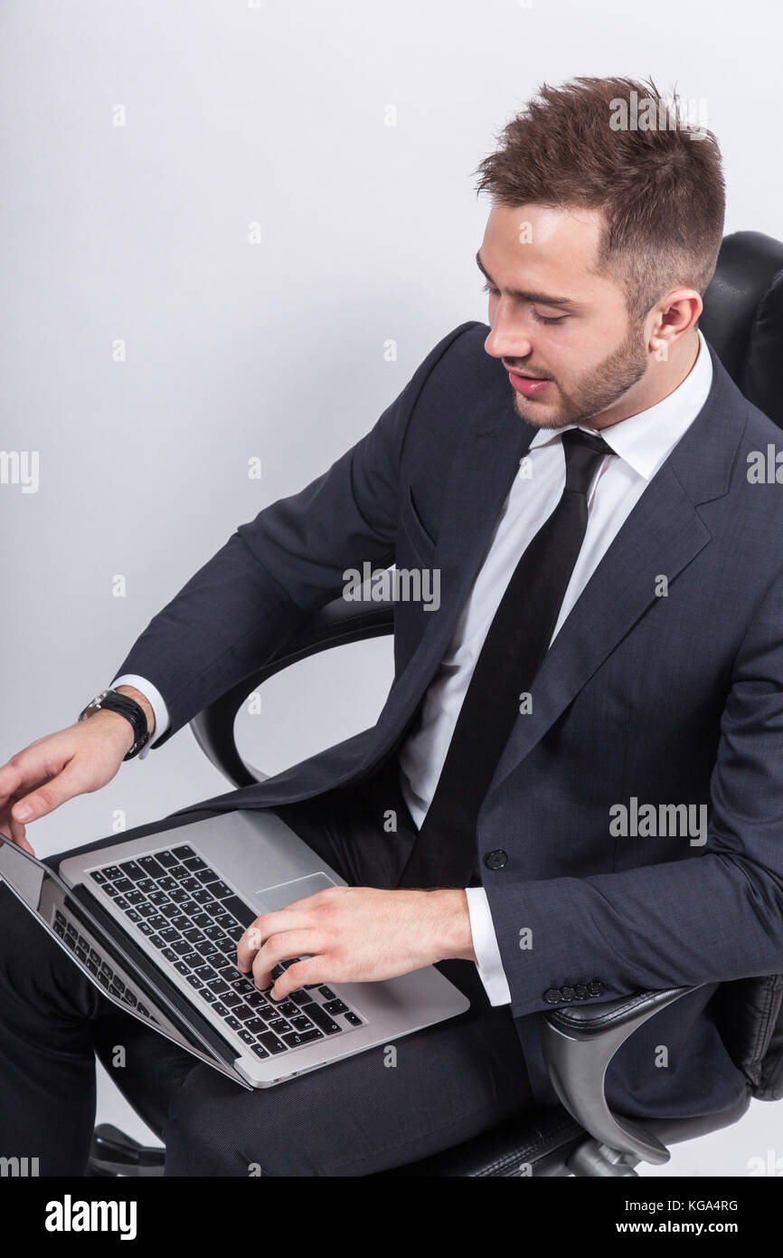 Picture of attractive businessman with computer Stock Photo - Alamy