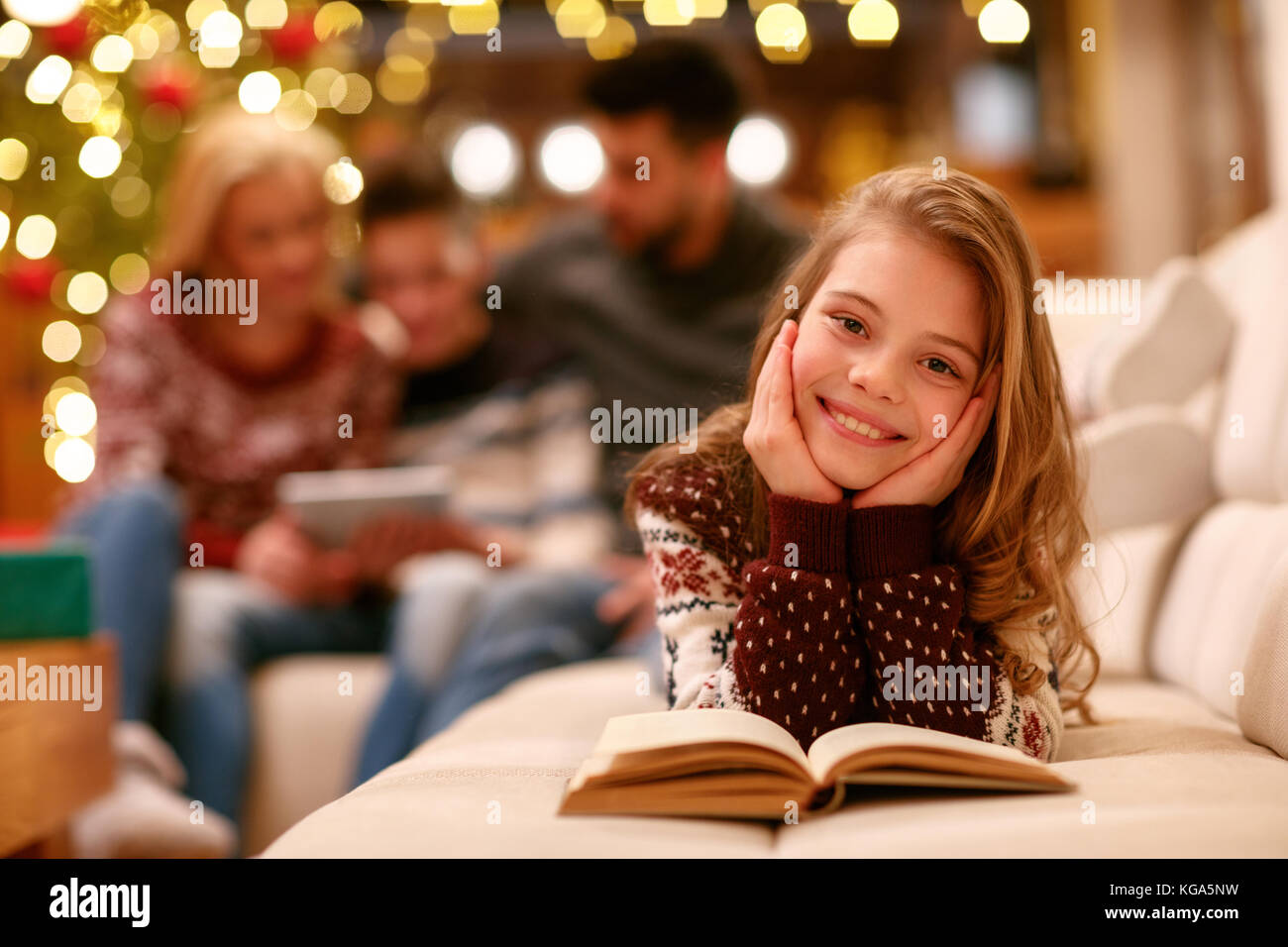 Portrait of cute girl with book Stock Photo - Alamy