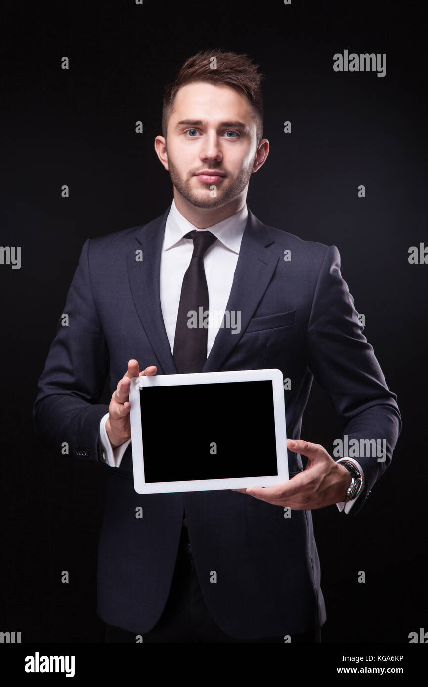 successful young businessman in a stylish business suit on a bla Stock Photo