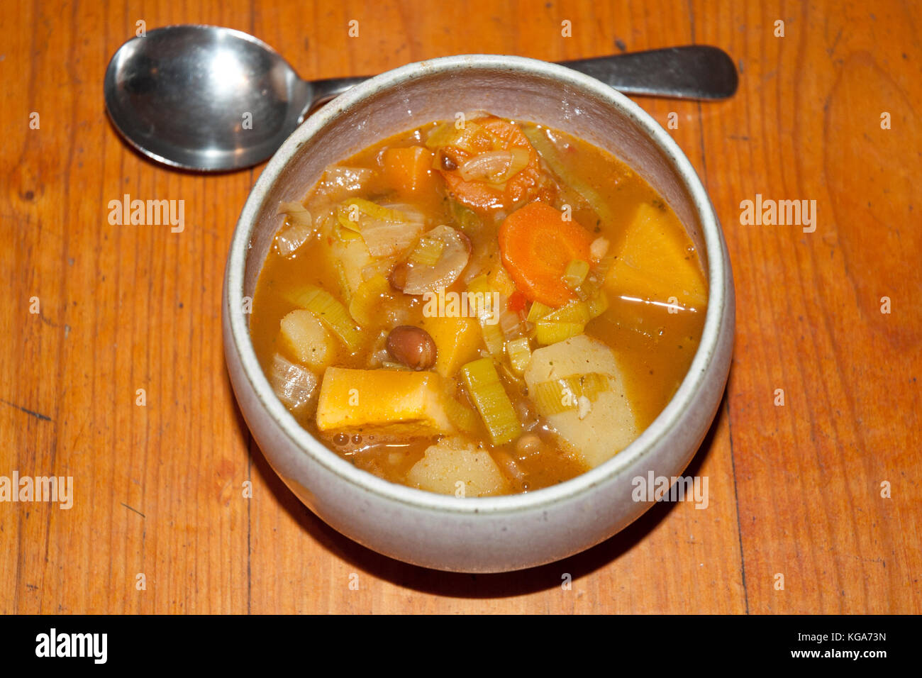 Bowl of rustic, chunky vegetable and bean soup/ stew, served on a