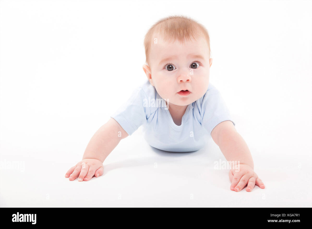 baby in the body lying on his stomach on a white background and Stock
