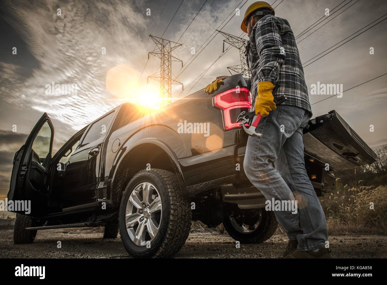 Caucasuan Contractor and His Pickup Truck. Field Job. Stock Photo