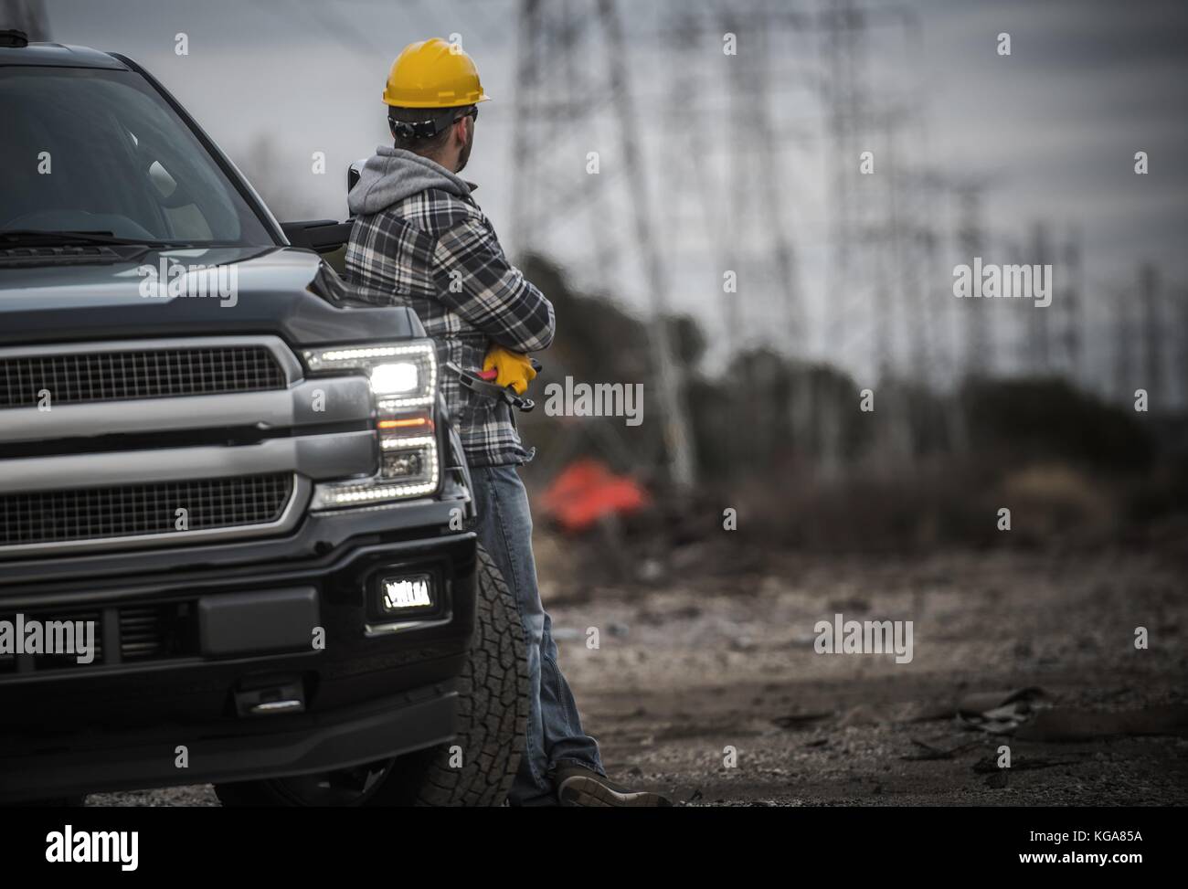 Caucasuan Contractor and His Pickup Truck. Field Job. Stock Photo