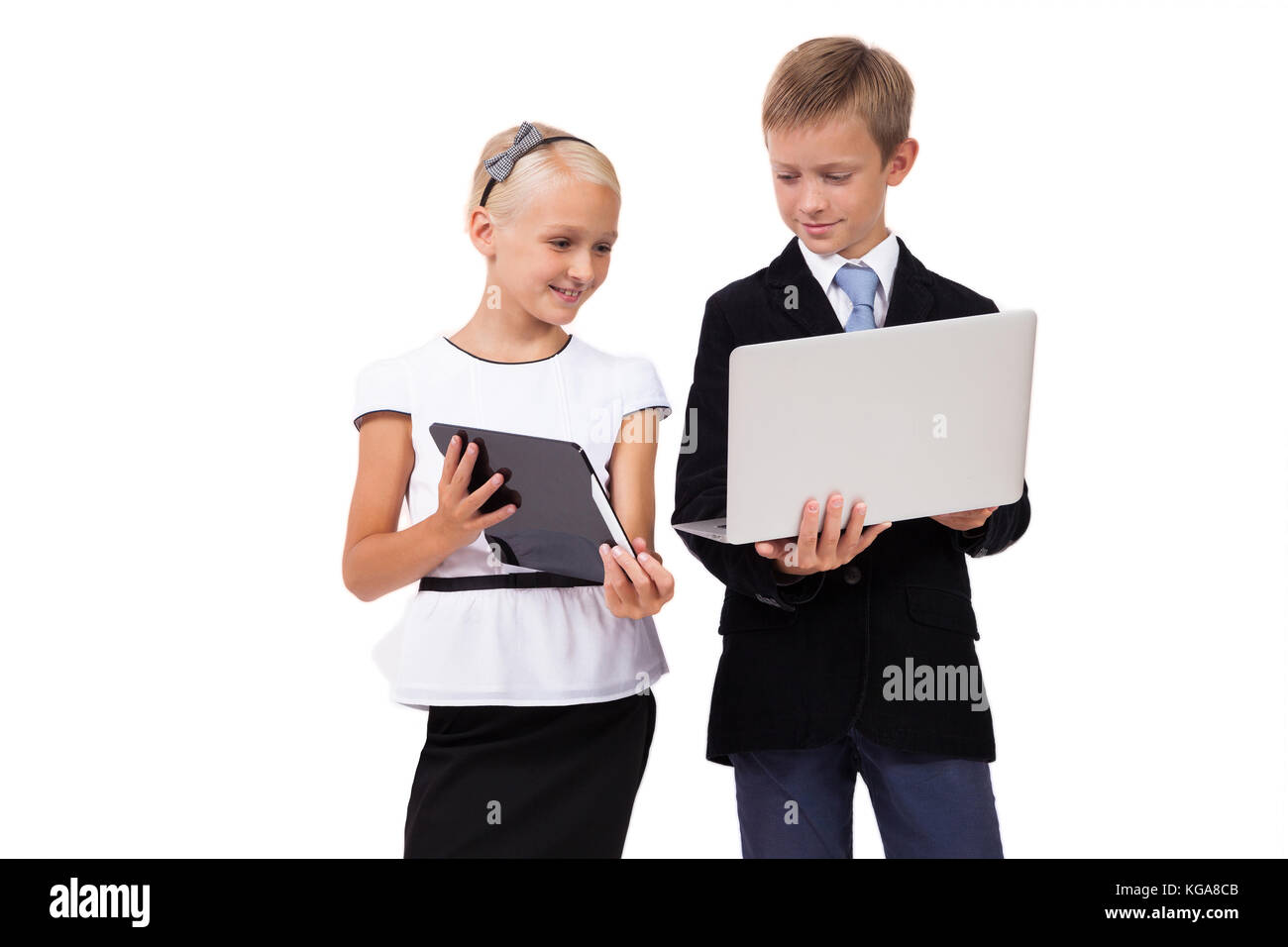schoolboy and schoolgirl with a laptop with a tablet on a white  Stock Photo