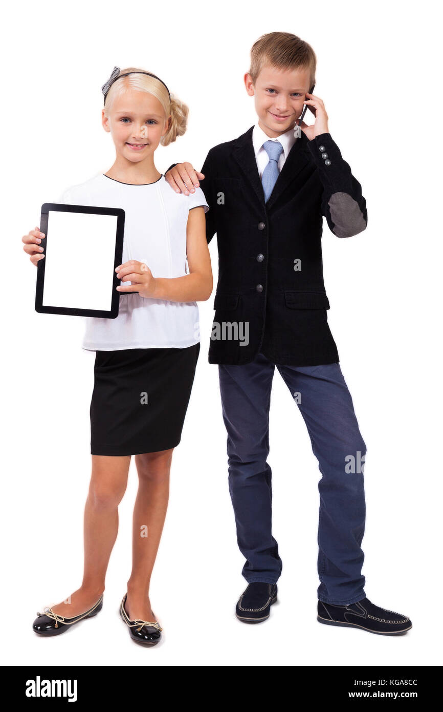 schoolboy and schoolgirl with a phone with a tablet on a white b Stock Photo
