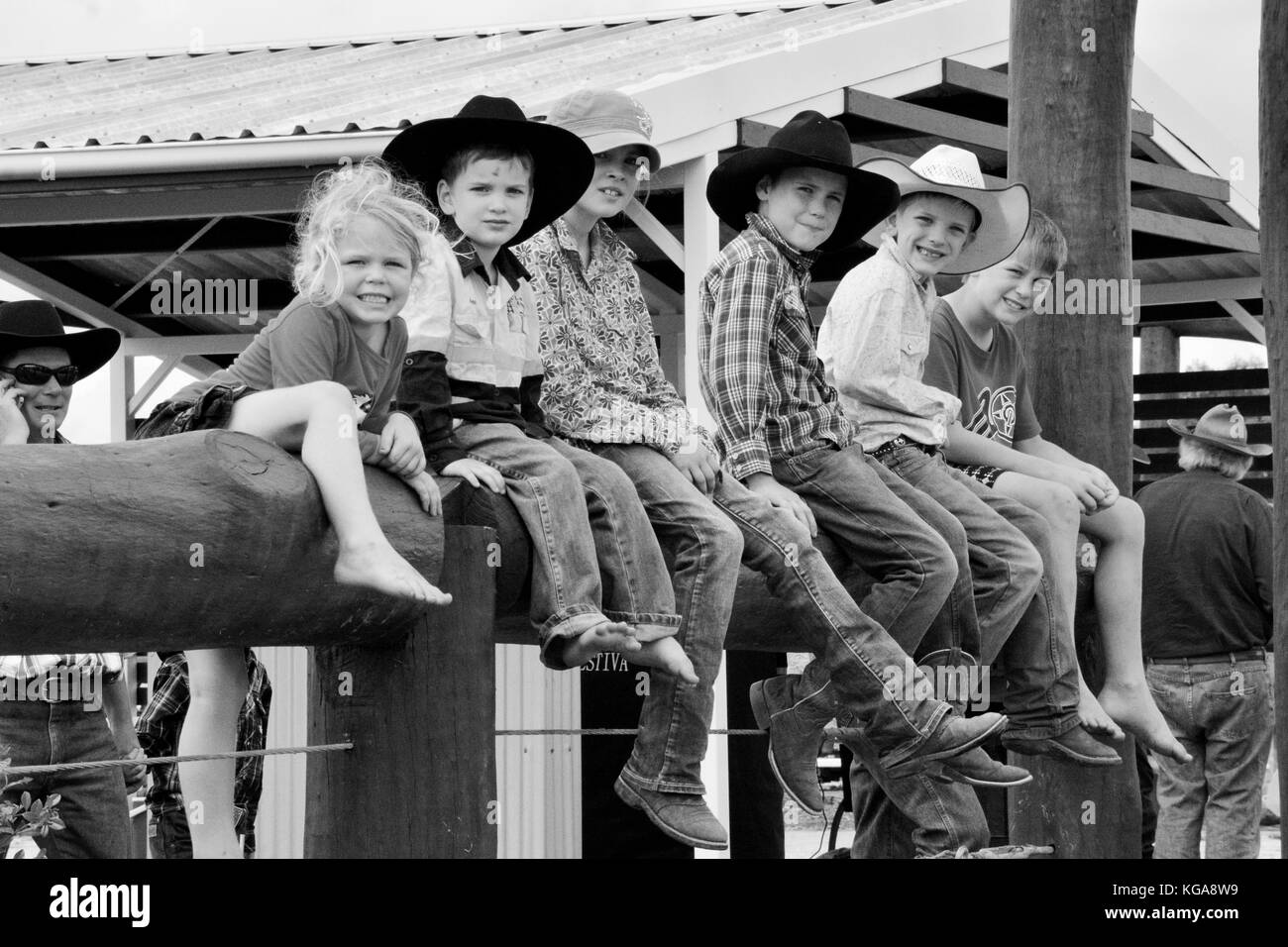 AUSTRALIAN COUNTRY KIDS SITTING ON FENCE. Stock Photo