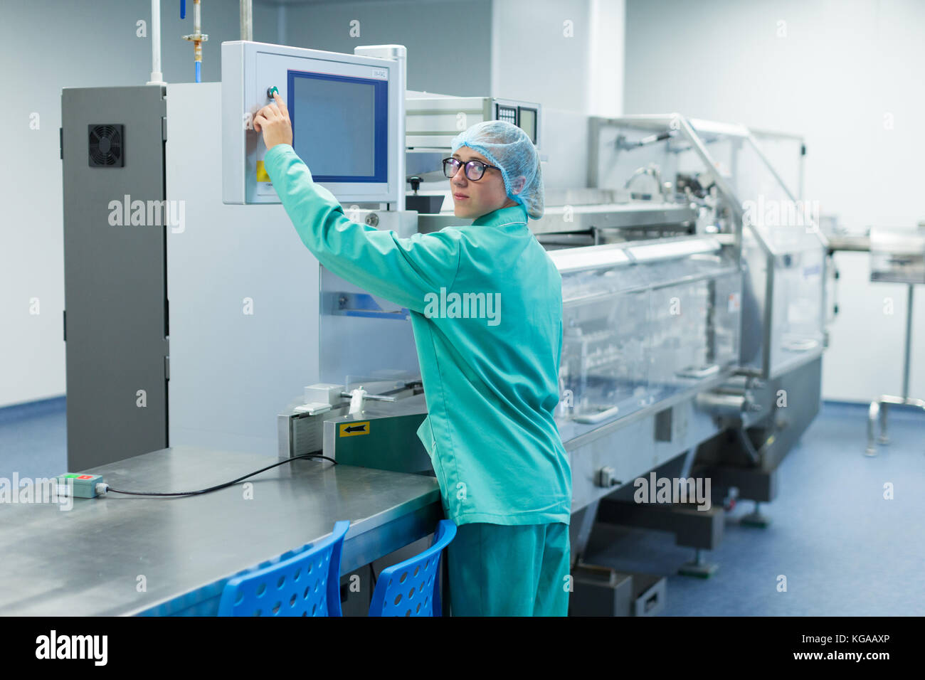 operator in the pharmaceutical factory near the equipment Stock Photo