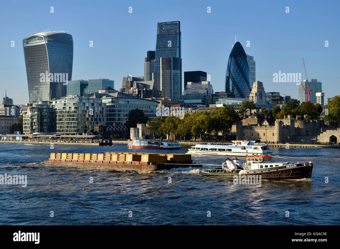 Cory Envirnomental container barge being pulled by tug boat Regain River Thames, London, UK, with London financial district behind. Stock Photo