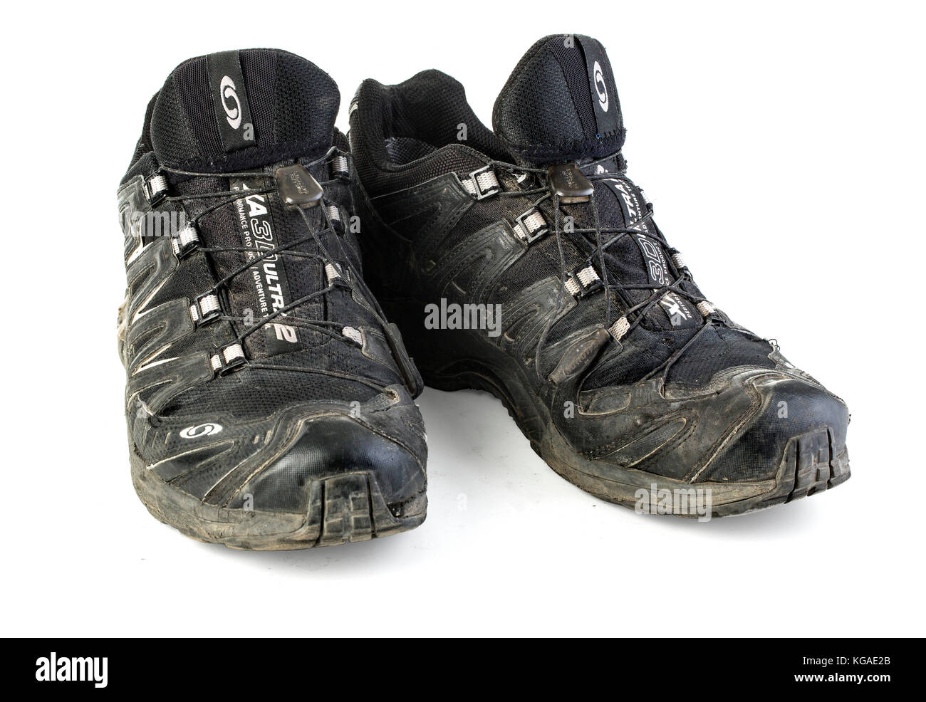 Chisinau, Moldova - December 24, 2015:: A pair of worn, ripped and dirty  Salomon trail running shoes over white background Stock Photo - Alamy