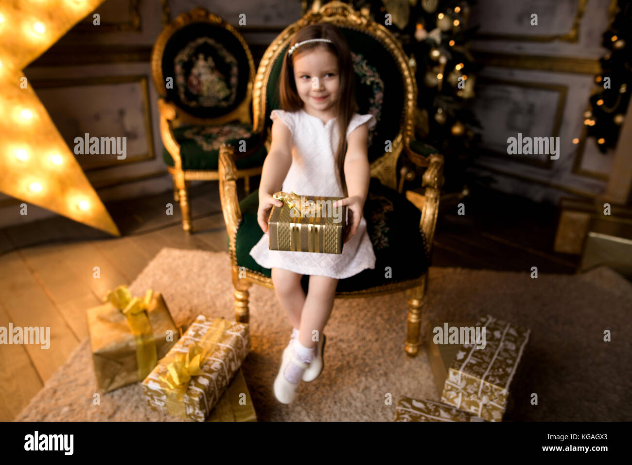 Happy little smiling girl with christmas gift box Stock Photo - Alamy