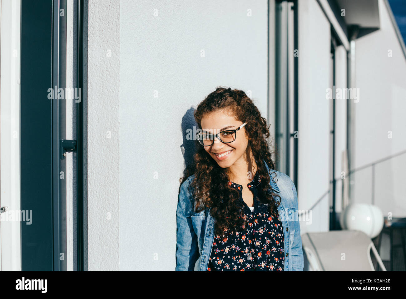 young beautiful woman with curly hair smiling Stock Photo - Alamy