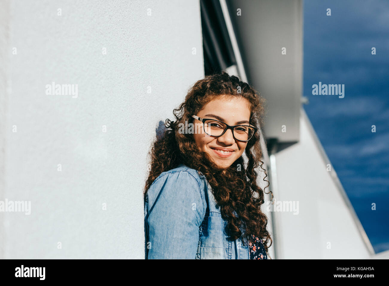 young beautiful woman with curly hair smiling Stock Photo - Alamy