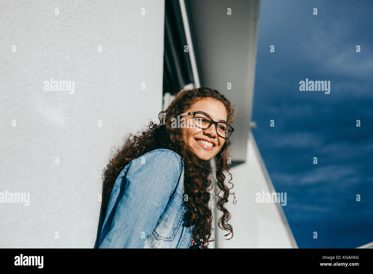 young beautiful woman with curly hair smiling Stock Photo - Alamy