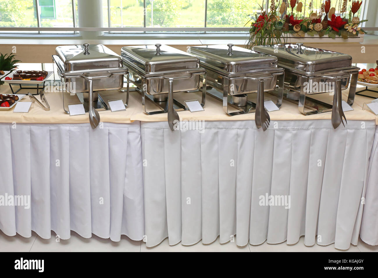 Row of stainless hotel pans on food warmers. Warm vegetable as side dishes.  Self-service buffet table. Celebration, party, birthday or wedding concept  Stock Photo - Alamy