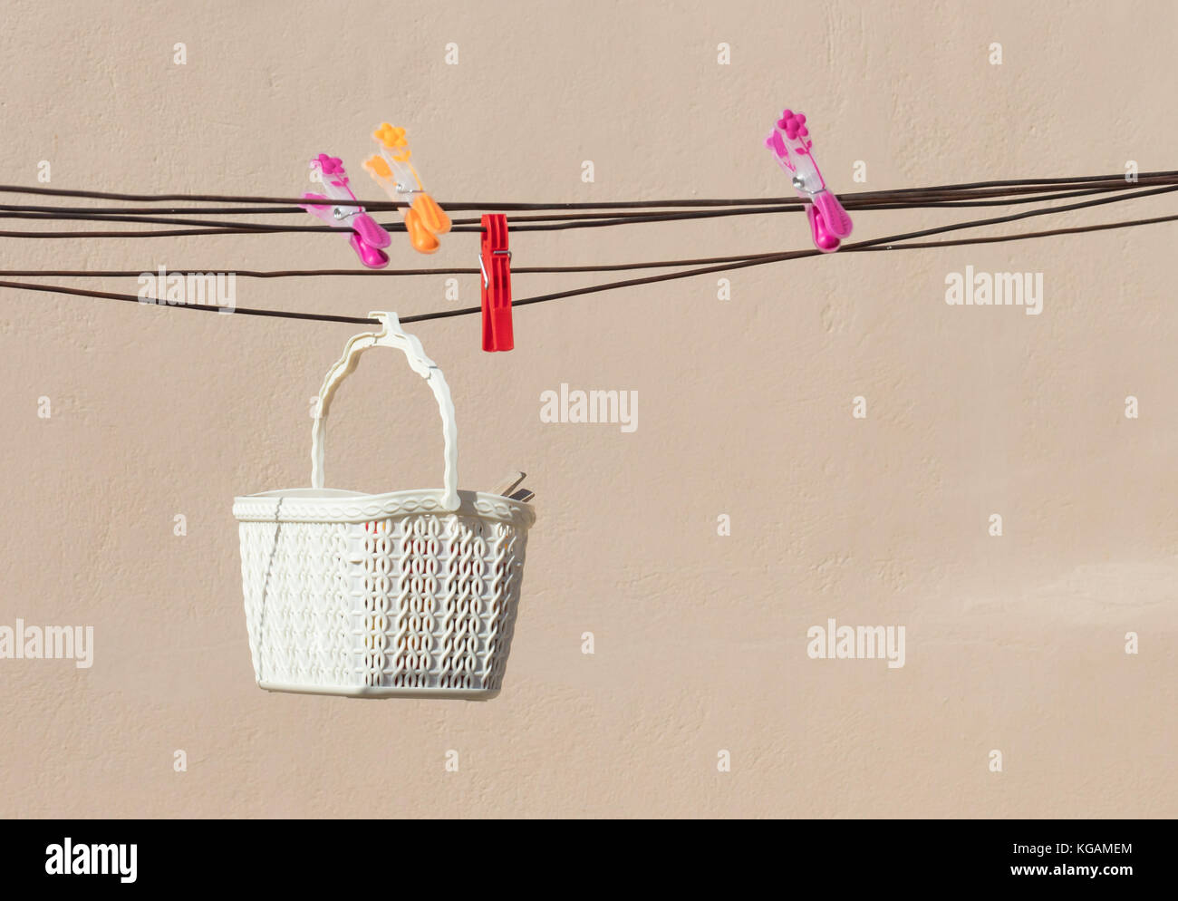 Simple white basket with clothespins, doing the loundry Stock Photo Alamy