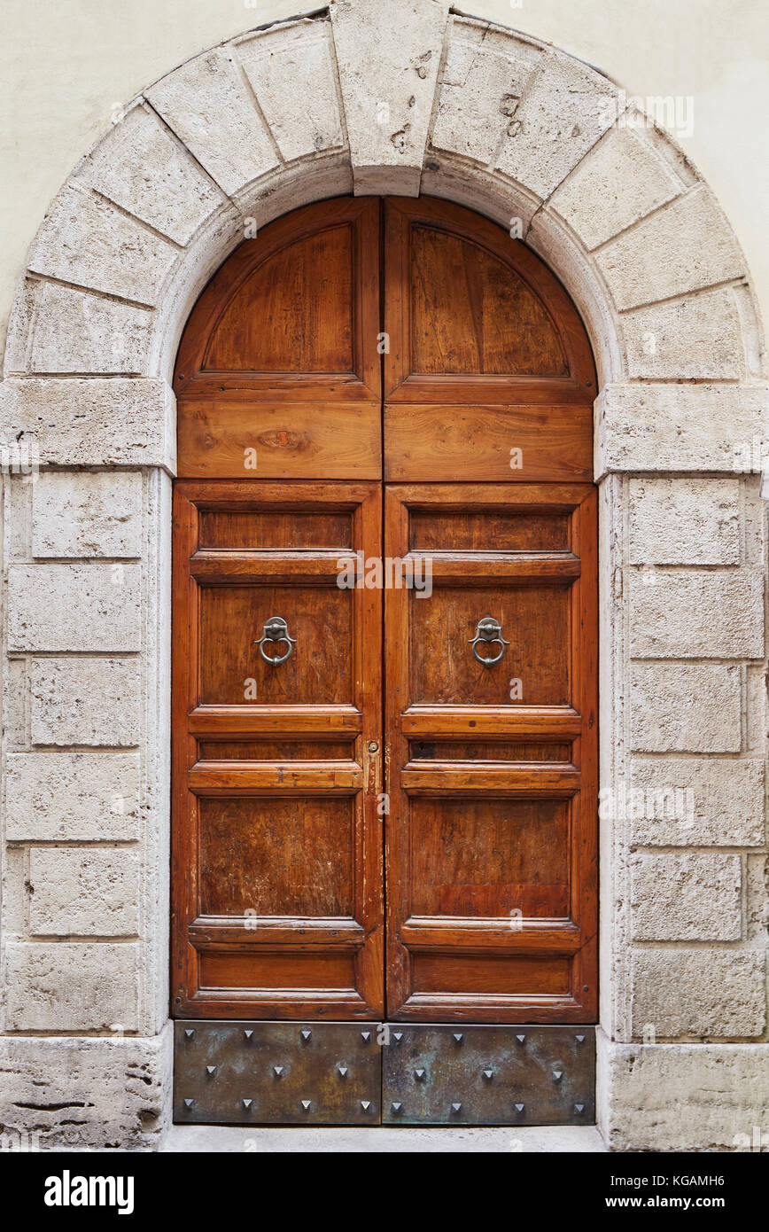 Old wooden brown door in a gray stone wall Rome, Italy Stock Photo - Alamy