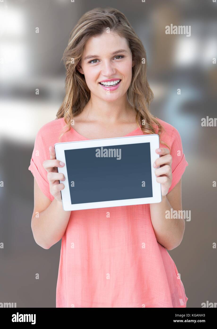 Digital composite of Woman holding tablet with office background Stock ...