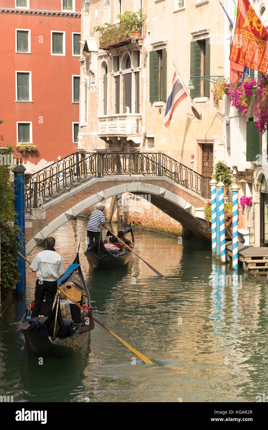 Italy, Venice, gondola and Venetian flags along the Rio Della Fava near the Bridge of Sighs. Stock Photo